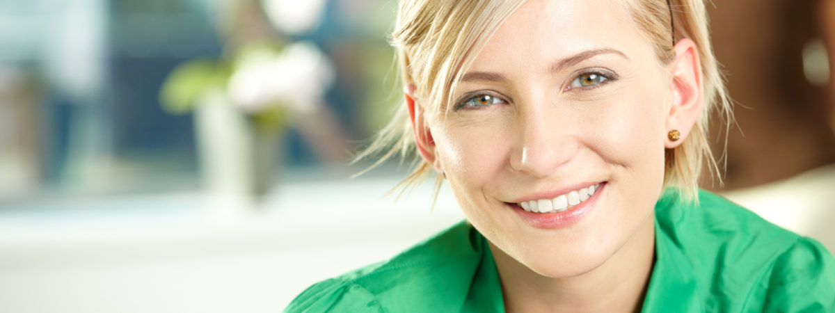 Woman with bright white teeth smiling confidently after professional teeth whitening